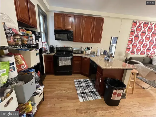 a kitchen with a sink appliances and cabinets