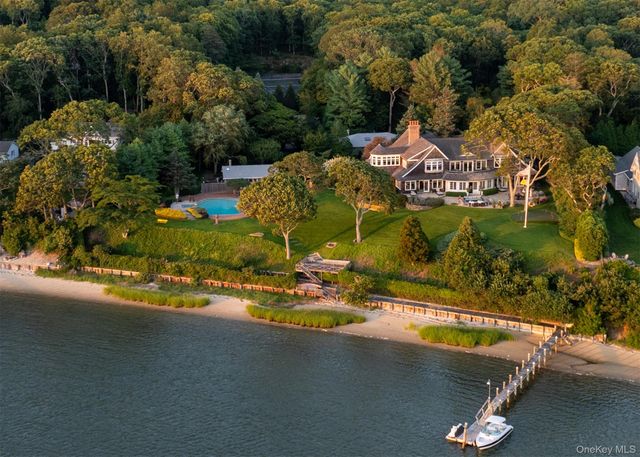 an aerial view of a house with garden space and lake view