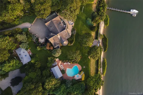an aerial view of a house with garden space and lake view