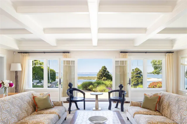 a bedroom with a large bed and a large window with outer view