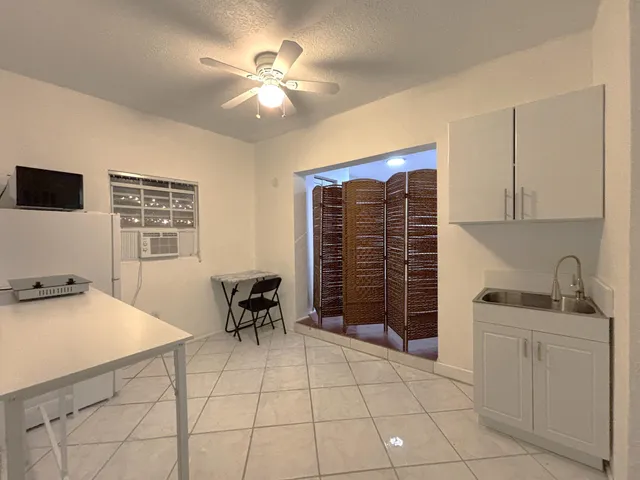 a kitchen with a cabinets and chairs