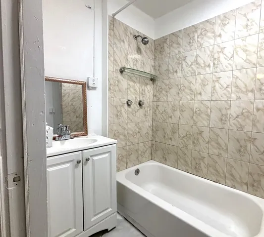 a bathroom with a granite countertop sink toilet and bathtub