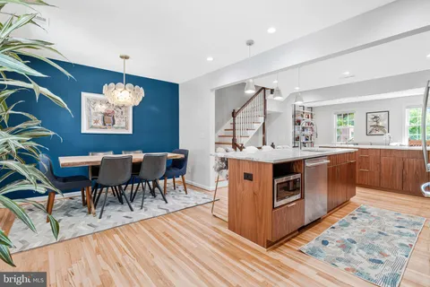 a kitchen with stainless steel appliances granite countertop a stove and a wooden floors