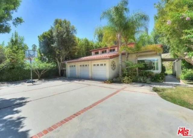 a couple of potted plants in front of building