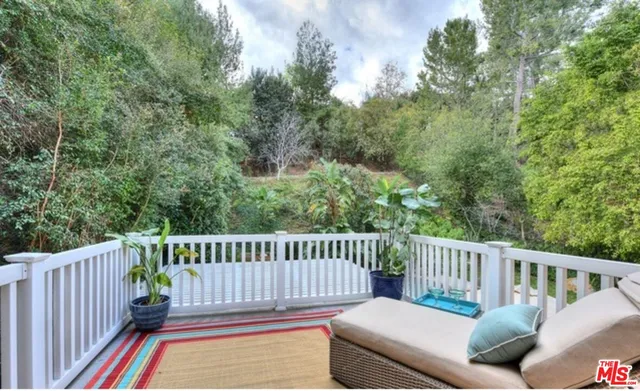 a view of backyard with seating and green space
