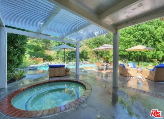 a view of a house with backyard and sitting area