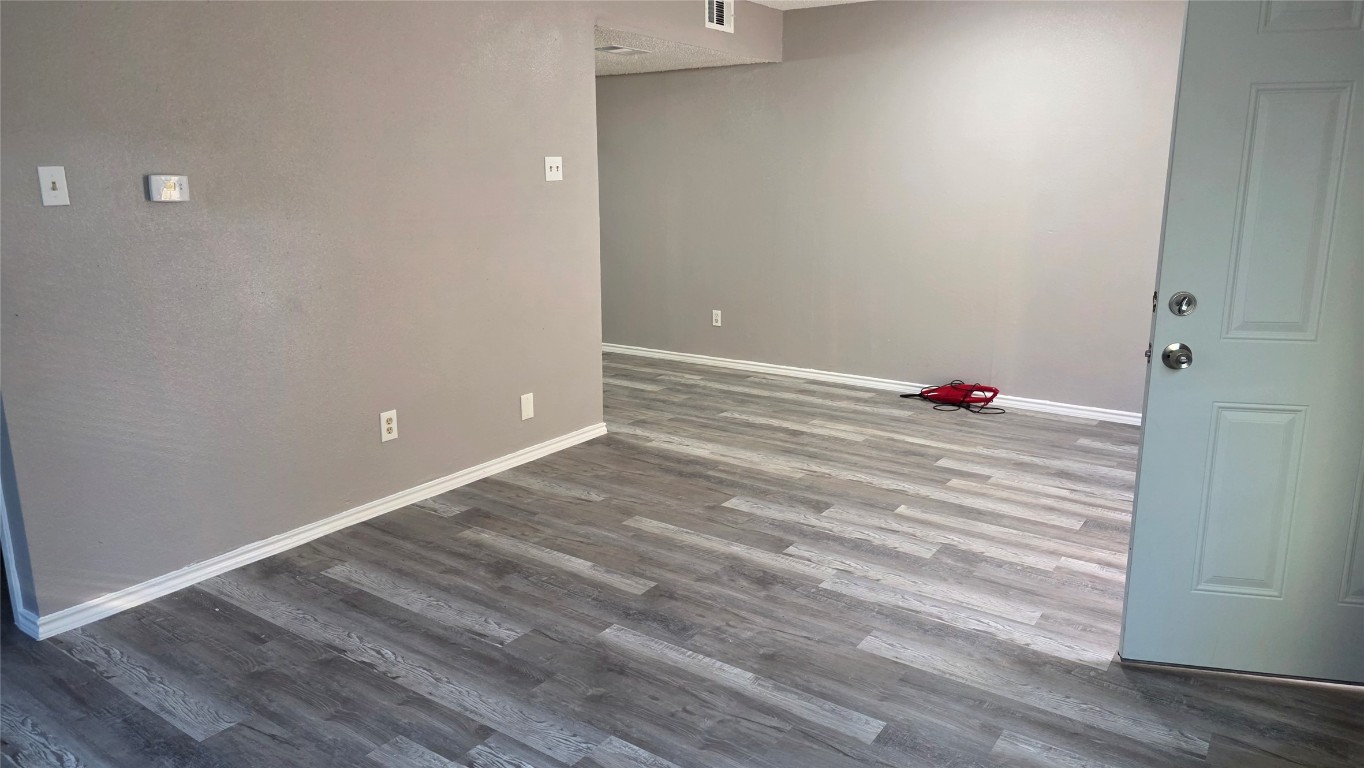 2124 Burton Drive, Unit 152 Austin, TX 78741 - Photo 9 of 16 a view of a room with wooden floor and white walls