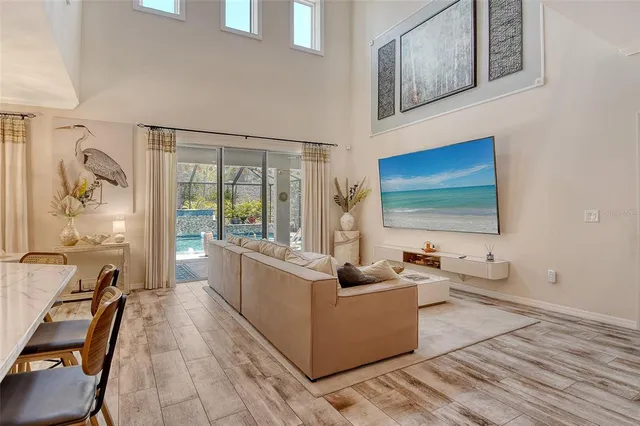 a kitchen with stainless steel appliances kitchen island granite countertop a stove a sink a refrigerator and blue cabinets with wooden floor