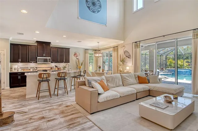 a kitchen with stainless steel appliances granite countertop wooden cabinets a stove a sink and dishwasher with wooden floor