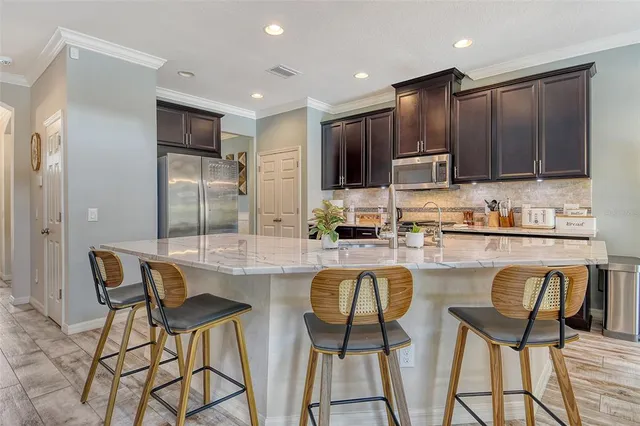 a bedroom with a bed and a flat tv screen on dresser