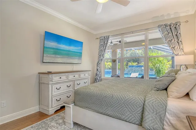 a bedroom with a large bed and a chandelier