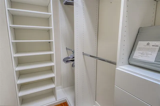 a dining room with furniture a rug and a floor to ceiling window
