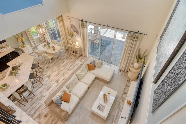 a dining room with furniture a rug and a floor to ceiling window