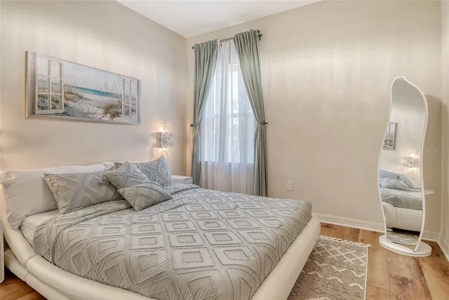 a view of swimming pool with outdoor seating and trees in the background