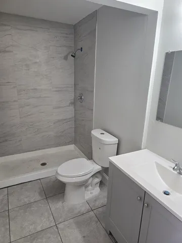 a bathroom with a toilet a sink and shower