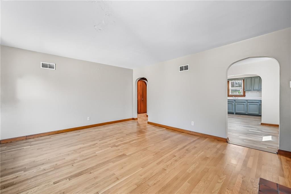 609 Park Avenue Farrell, PA 16121 - Photo 11 of 49 a view of an empty room with wooden floor and a window
