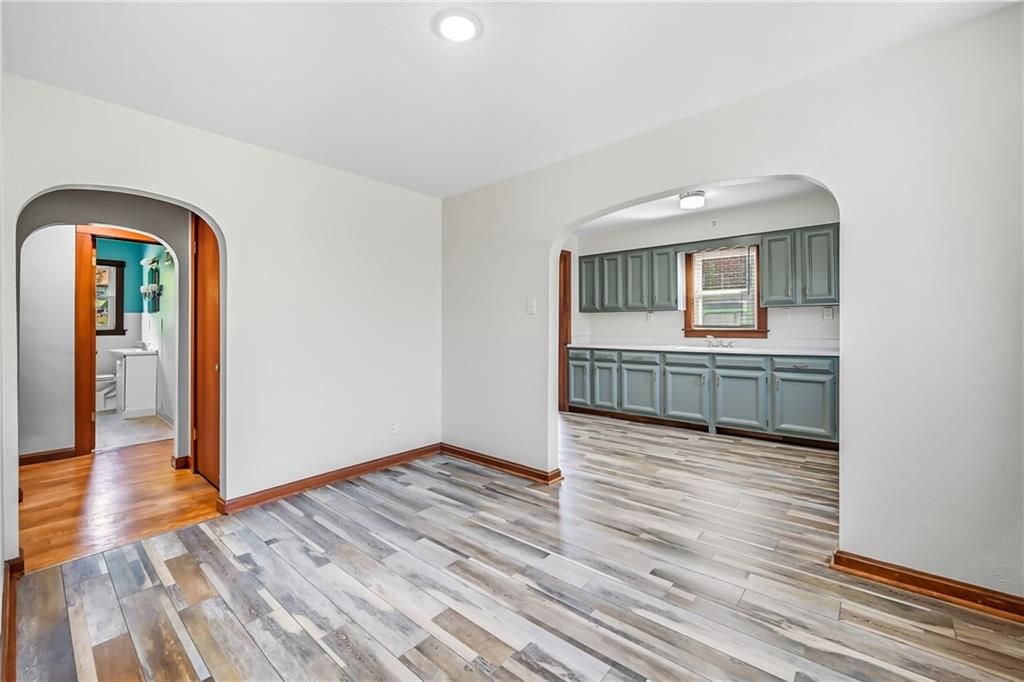 609 Park Avenue Farrell, PA 16121 - Photo 14 of 49 a view of an empty room with wooden floor and a window