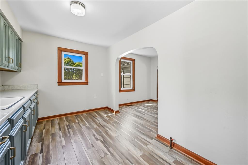 609 Park Avenue Farrell, PA 16121 - Photo 15 of 49 a view of an empty room with wooden floor and a window