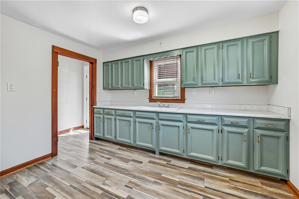 609 Park Avenue Farrell, PA 16121 - Photo 16 of 49 a kitchen with a sink cabinets and wooden floor