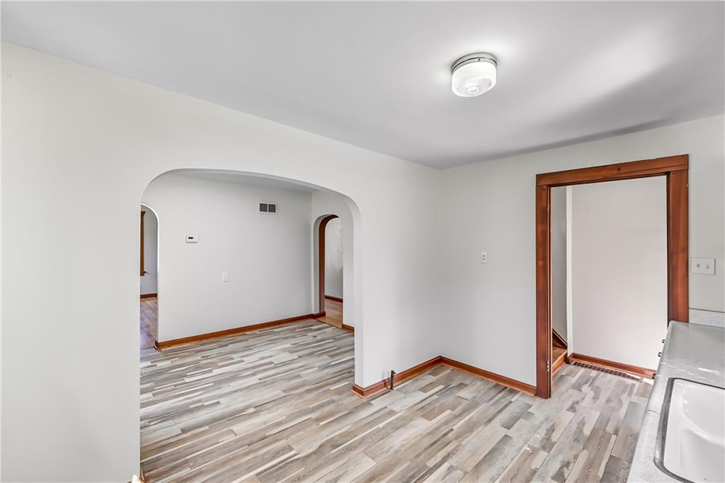 609 Park Avenue Farrell, PA 16121 - Photo 20 of 49 an empty room with wooden floor and a window