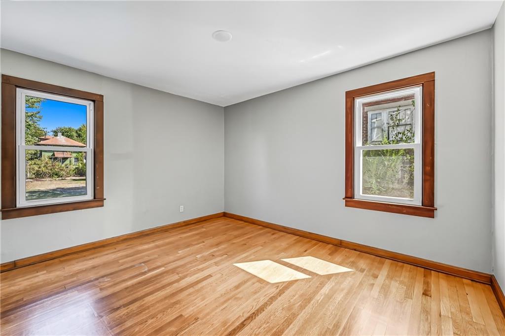 609 Park Avenue Farrell, PA 16121 - Photo 22 of 49 a view of an empty room with window and wooden floor