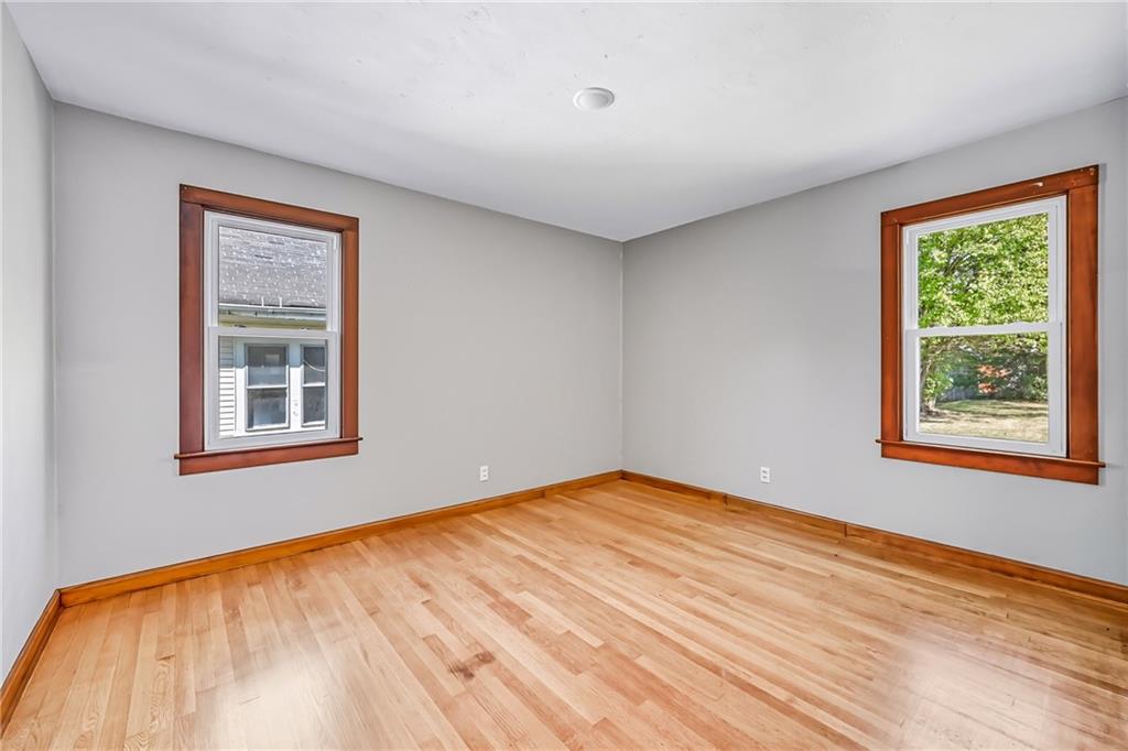 609 Park Avenue Farrell, PA 16121 - Photo 27 of 49 a view of an empty room with wooden floor and a window
