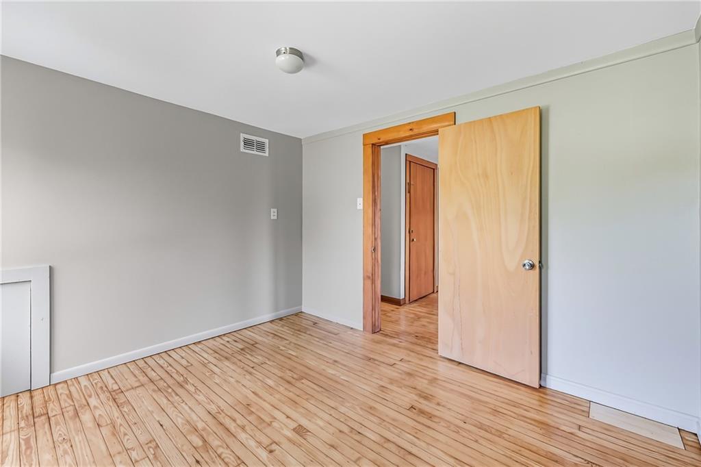 609 Park Avenue Farrell, PA 16121 - Photo 33 of 49 a view of an empty room with wooden floor and a window