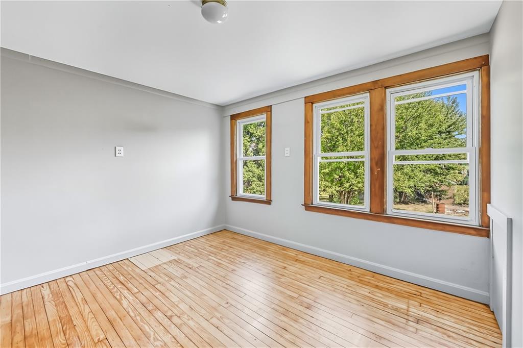 609 Park Avenue Farrell, PA 16121 - Photo 35 of 49 a view of an empty room with wooden floor and a window