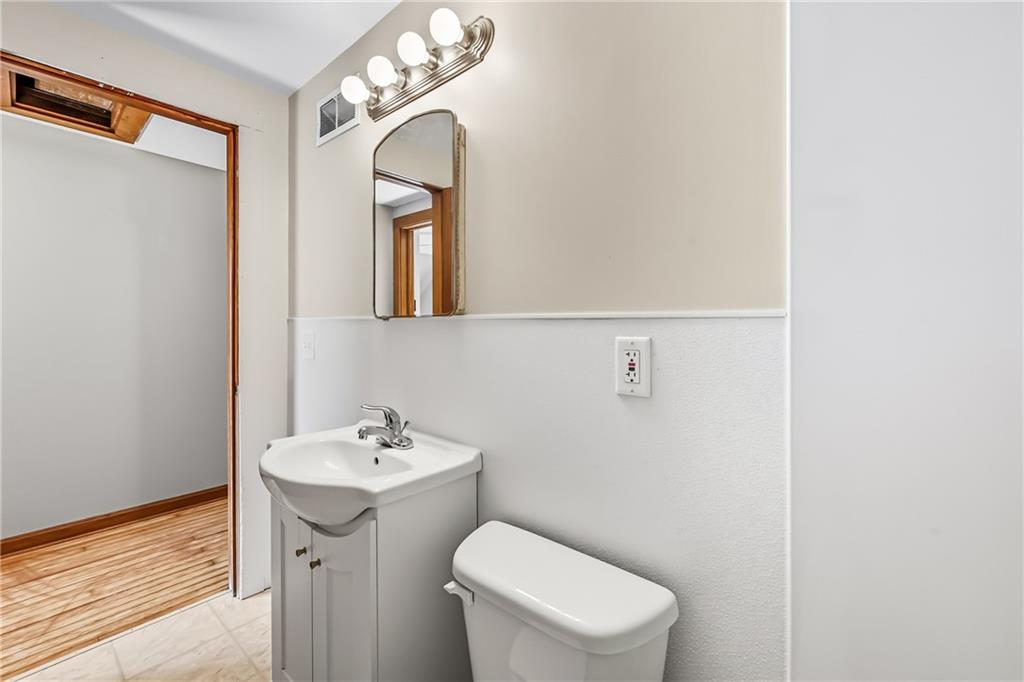 609 Park Avenue Farrell, PA 16121 - Photo 38 of 49 a bathroom with a toilet a sink and mirror