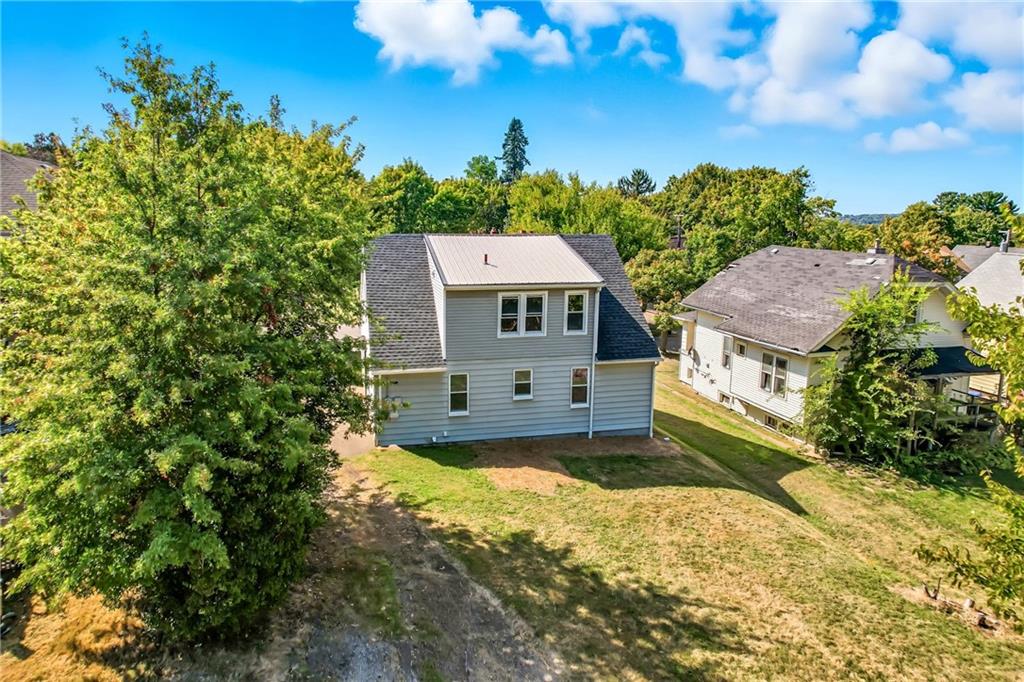 609 Park Avenue Farrell, PA 16121 - Photo 6 of 49 a view of a big house with a big yard and large tree