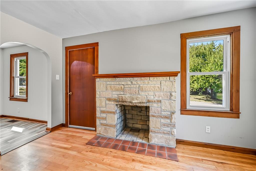 609 Park Avenue Farrell, PA 16121 - Photo 8 of 49 a view of an empty room with wooden floor fireplace and a window