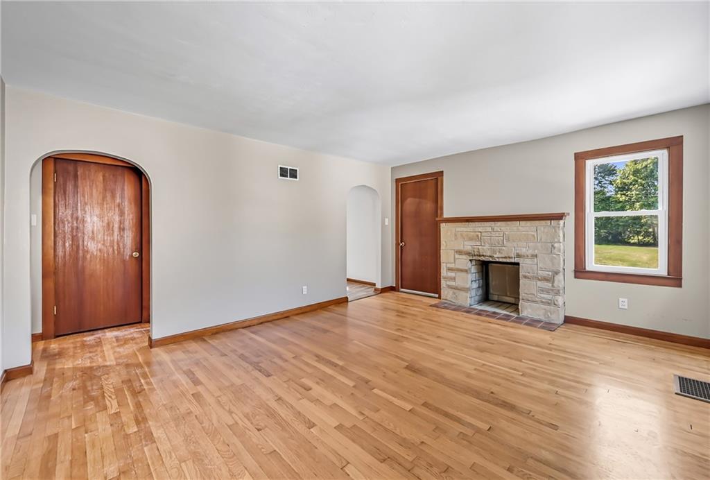 609 Park Avenue Farrell, PA 16121 - Photo 9 of 49 a view of an empty room with wooden floor fireplace and a window