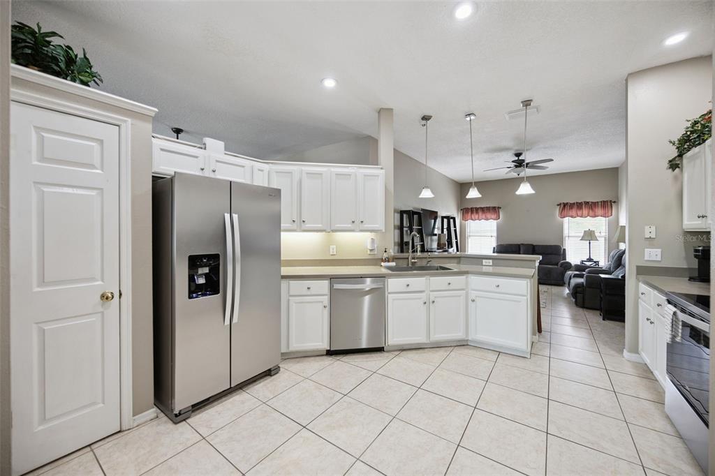 261 Mill Slough Road Oviedo, FL 32766 - Photo 13 of 62 a kitchen with stainless steel appliances a refrigerator sink and microwave