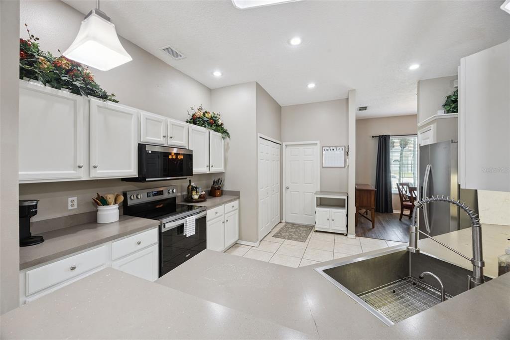 261 Mill Slough Road Oviedo, FL 32766 - Photo 15 of 62 a kitchen with stainless steel appliances granite countertop a sink a stove and a refrigerator