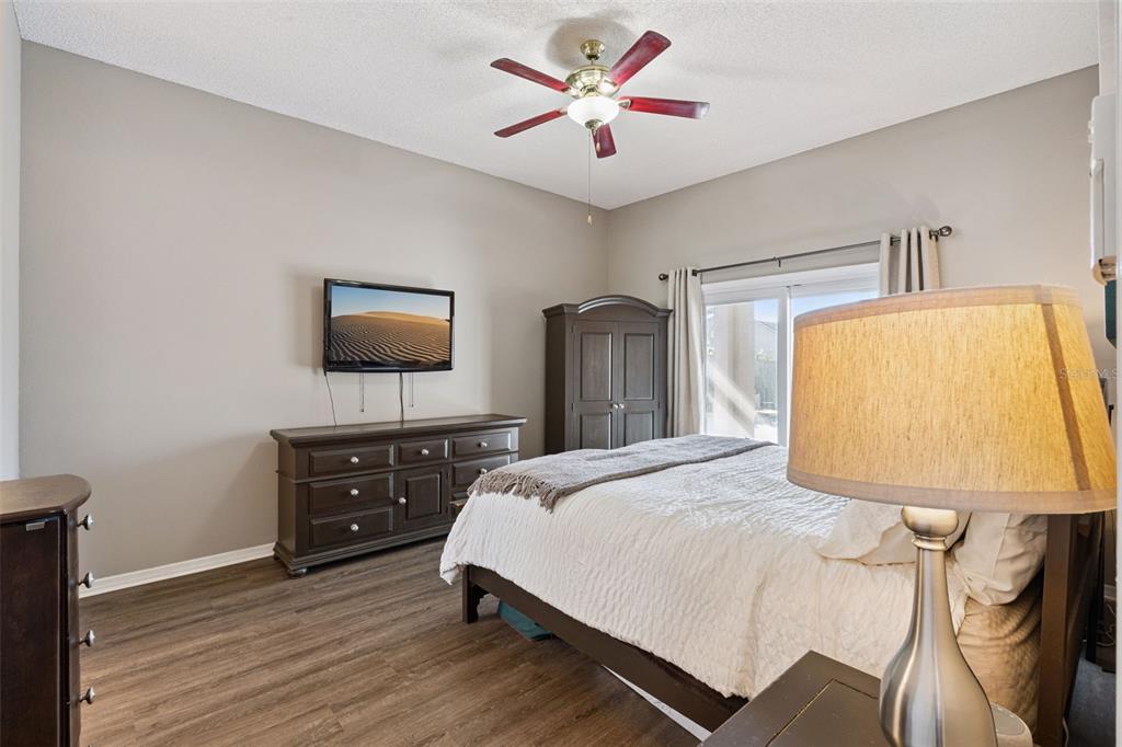261 Mill Slough Road Oviedo, FL 32766 - Photo 24 of 62 a bedroom with a bed and a flat screen tv