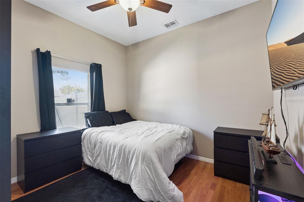 261 Mill Slough Road Oviedo, FL 32766 - Photo 27 of 62 a bedroom with a bed and a ceiling fan
