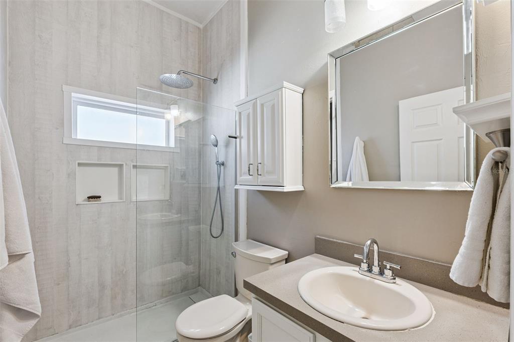 261 Mill Slough Road Oviedo, FL 32766 - Photo 28 of 62 a bathroom with a sink toilet a mirror and shower