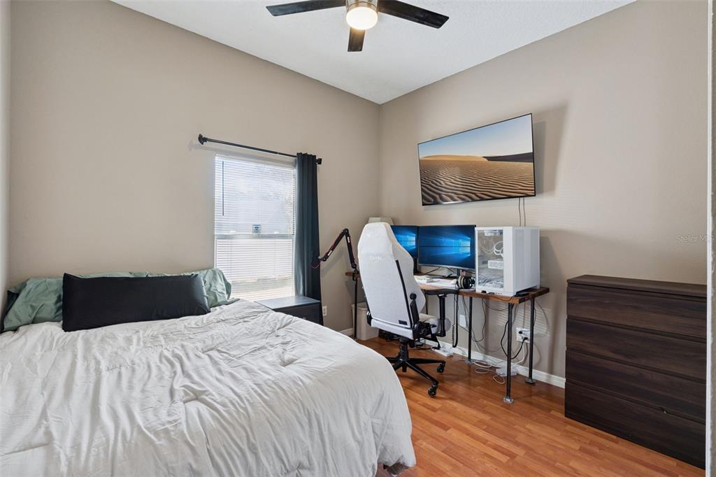 261 Mill Slough Road Oviedo, FL 32766 - Photo 29 of 62 a bedroom with a bed and wooden floor