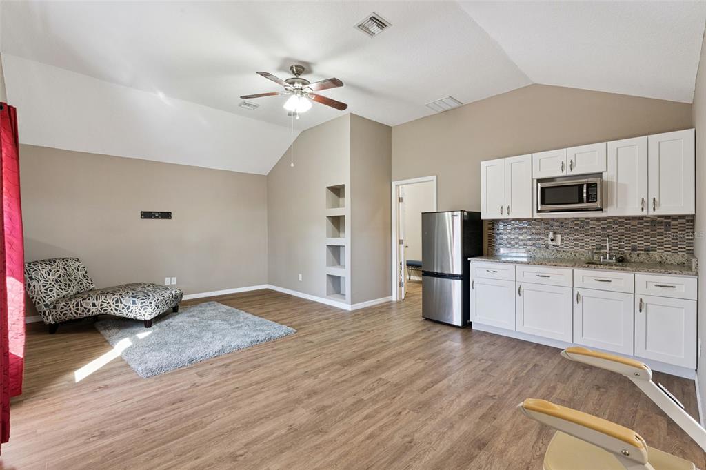 261 Mill Slough Road Oviedo, FL 32766 - Photo 31 of 62 a kitchen with kitchen island a sink appliances and cabinets