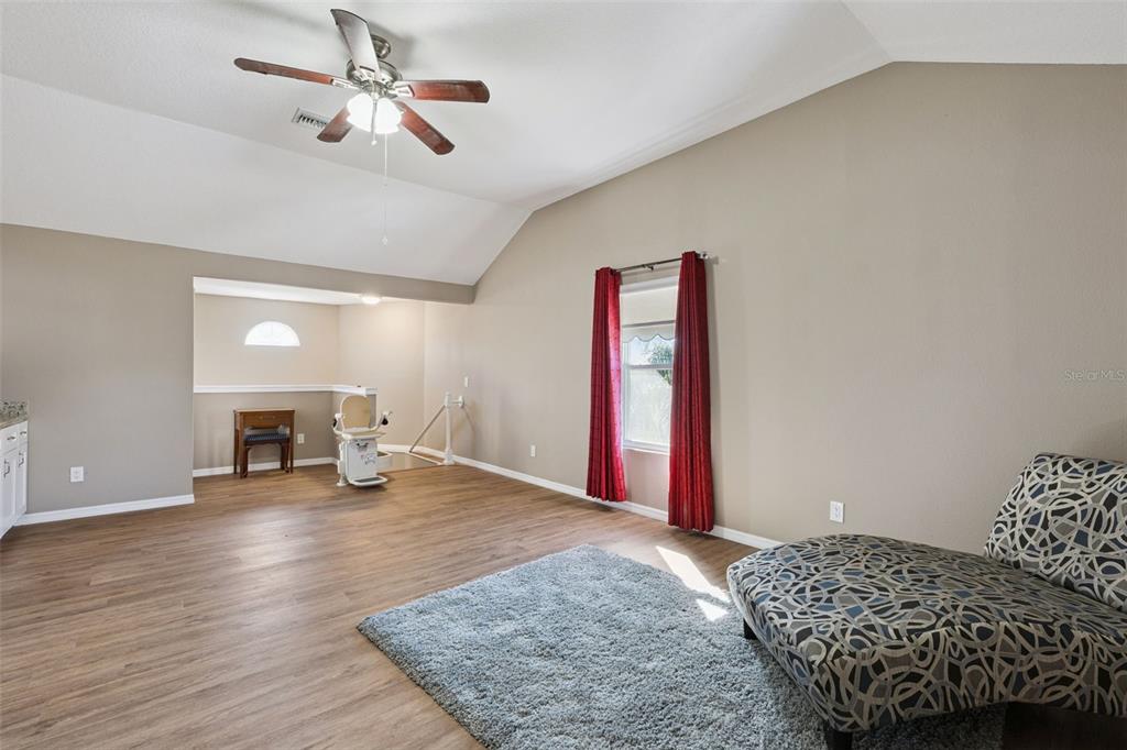 261 Mill Slough Road Oviedo, FL 32766 - Photo 33 of 62 a spacious bedroom with a bed and a chandelier