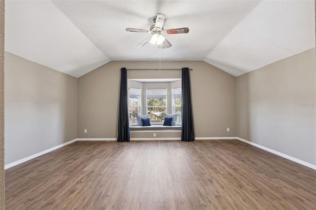 261 Mill Slough Road Oviedo, FL 32766 - Photo 36 of 62 a view of an empty room with wooden floor and a window