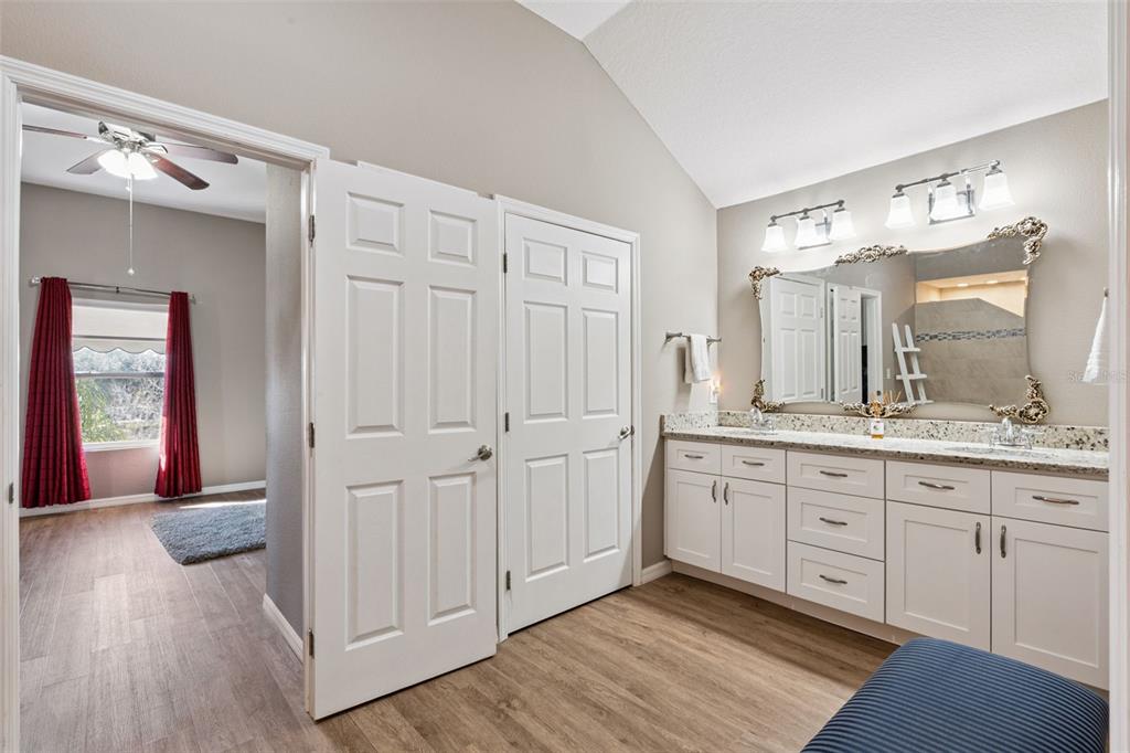 261 Mill Slough Road Oviedo, FL 32766 - Photo 39 of 62 a spacious bathroom with a granite countertop sink a mirror and a shower