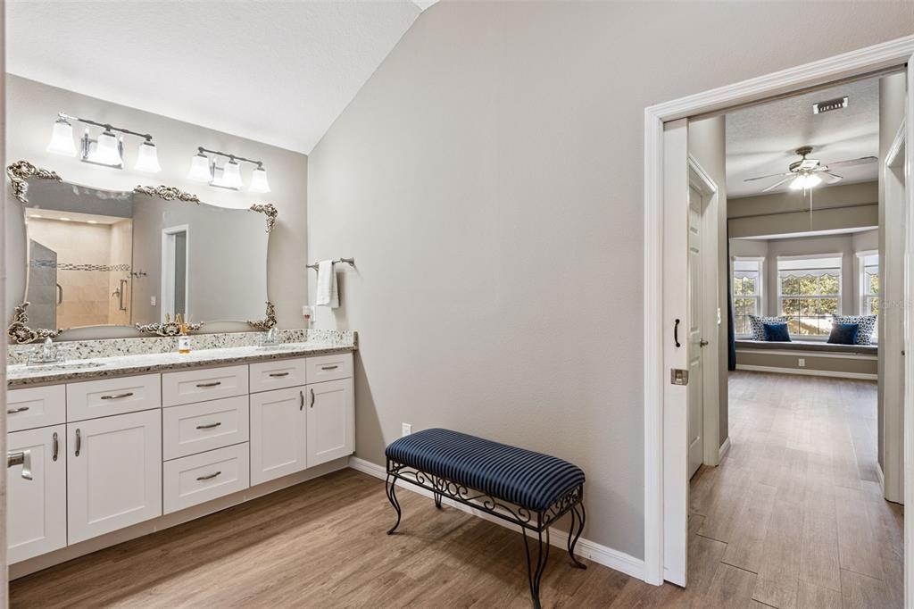 261 Mill Slough Road Oviedo, FL 32766 - Photo 40 of 62 a spacious bathroom with a granite countertop sink mirror and a