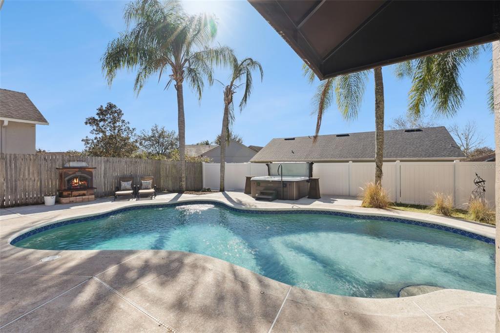 261 Mill Slough Road Oviedo, FL 32766 - Photo 43 of 62 a view of a swimming pool with a lounge chairs