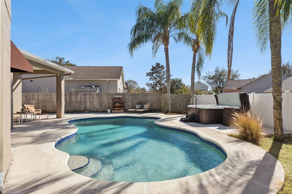 261 Mill Slough Road Oviedo, FL 32766 - Photo 44 of 62 a view of a backyard with a patio and swimming pool