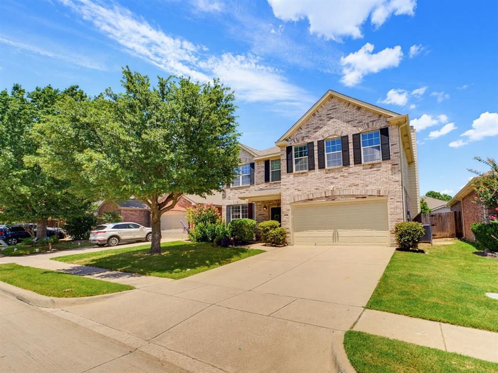 13268 Fencerow Road Fort Worth, TX 76244 - Photo 2 of 25 Two-story residence featuring a brick and stone facade, a two-car garage, and a concrete driveway