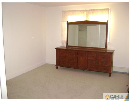 14 Mercury Road Edison, NJ 08817 - Photo 3 of 7 a view of a dresser in front of a window