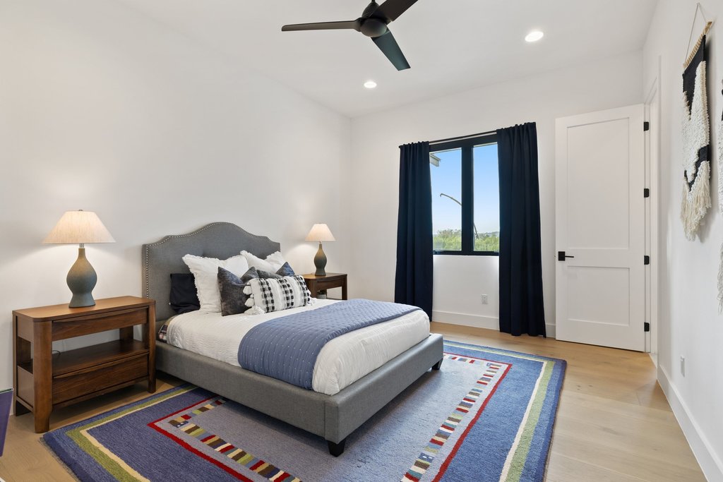 6316 Caudill Lane Austin, TX 78738 - Photo 25 of 40 Bedroom featuring a ceiling fan, light wood-style flooring, and recessed lighting