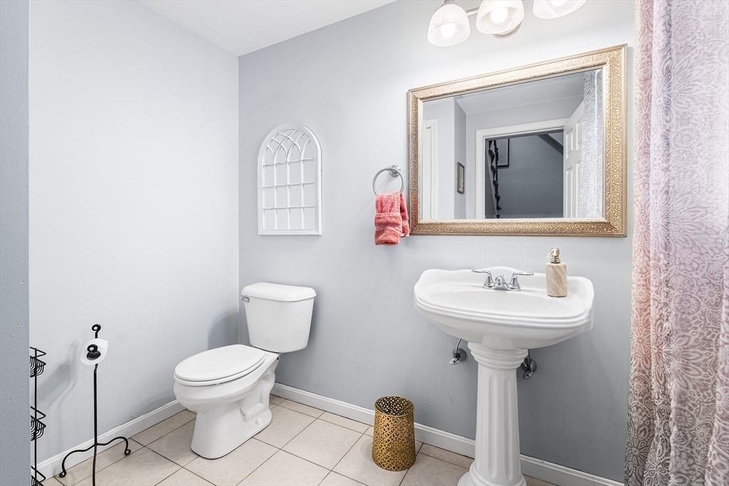 52 Deanville Road Attleboro, MA 02703 - Photo 11 of 30 a bathroom with a toilet sink and mirror