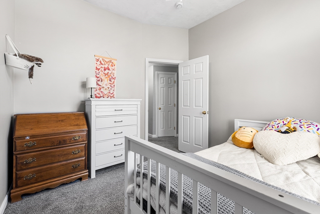 52 Deanville Road Attleboro, MA 02703 - Photo 16 of 30 a bedroom with a bed and a cabinets